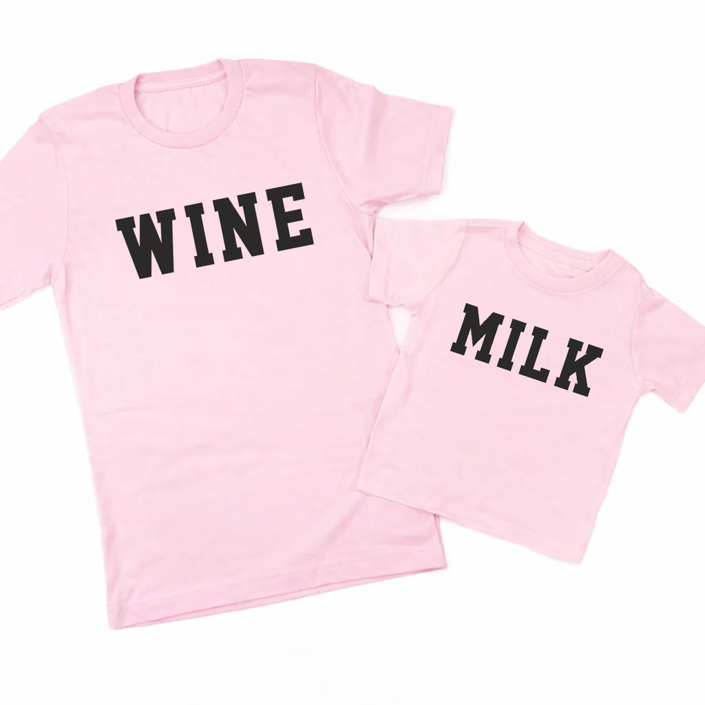 Two pink t-shirts, one with 'WINE' and the other with 'MILK', on a white background.
