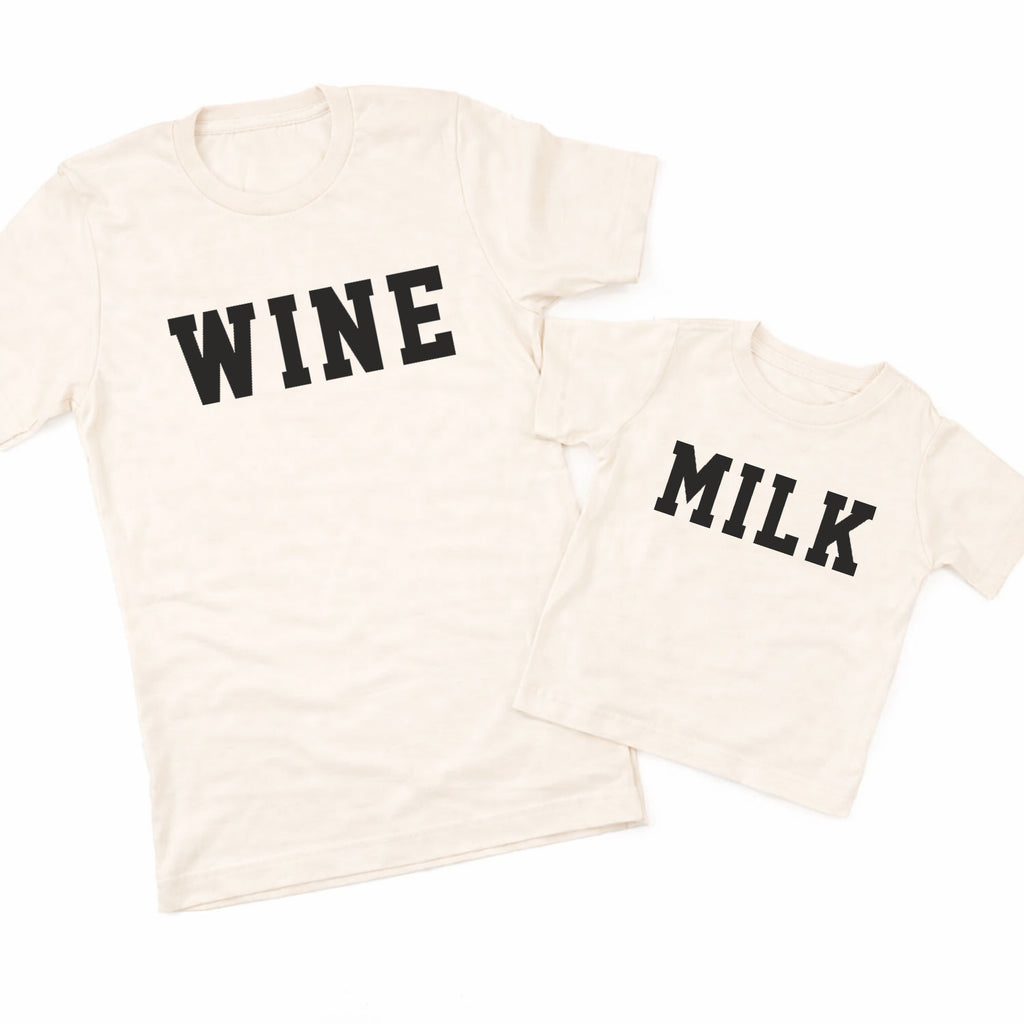 Two cream-colored t-shirts with 'WINE' and 'MILK' text on a white background